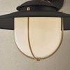Close-up showing opal glossy glass diffuser and patina brass cage details
