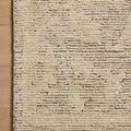 Corner close-up of Penny wool rug on wooden floor highlighting pile detail and muted pattern