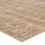Close-up showing metallic polyester fibers and textured weave of gold and taupe geometric pattern