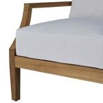 Close-up of wider teak armrest edge and sofa base frame under cushion