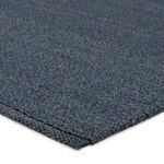 Close-up of dense looped texture and folded edge of Ryker deep blue rug