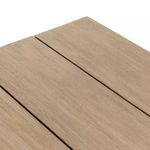 Extreme close-up showing the natural grain and finish of one slat on the table’s top