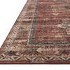 Low angled side view focusing on the rug’s intricate patterned border and flat weave texture