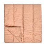Folded quilt showing stitching detail and reversible texture on fabric's underside