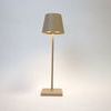 Vera Sand Poldina Mini Table Lamp turned on showing warm light beneath the shade