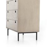 angled lower side view emphasizing raised iron legs and panel edges on grey washed wood