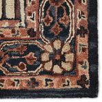 Close-up of rug corner showing dense hand-tufted loops and detailed floral patterns