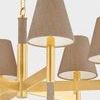 Close-up revealing textured grasscloth fabric on shade and detailed brass fitting on stem