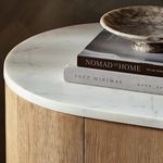 Styled sideboard top with stacked books and small decorative bowl on marble