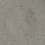 Macro detail of speckled glaze texture revealing earthy clay and small dark inclusions