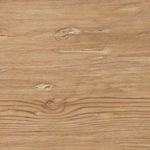 Cropped angled shot of table corner with visible leg taper and wood grain