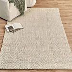 Chevron jute rug styled in living room with sofa, wooden floor, and open book on rug