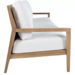 Side profile emphasizing sofa seat depth and plush white cushions on teak frame