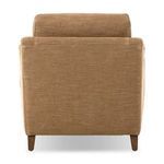 Back view of Lynne chair revealing simple tapered wood legs and tight back fabric