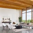Front three-quarter perspective of Caleb Small Ivory Angora Accent Chair showing plush cushions and black metal legs