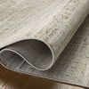 Partially rolled rug showing woven backing and flexible polyester construction