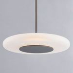 Pendant light illuminated, showing warm glow through etched glass against grey background