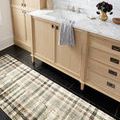 Humphrey Forest runner rug in bathroom with marble countertop and light wood cabinetry