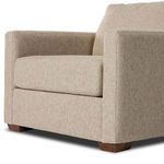 Angled rear close-up capturing upholstered back and side panels with subtle texture