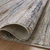 Detail close-up of folded edge reveals tight weave and polyester pile texture