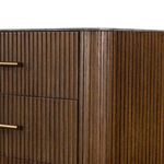Close-up of rounded corner with vertical reeding and the contrast where the bluestone top meets the wood.
