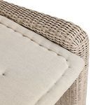 Extreme close-up showing fine rattan weave detail near backrest seam and cushion edge
