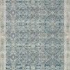 Blue and beige Mika Ocean Rug with intricate abstract tribal geometric patterns and blanket-stitch border