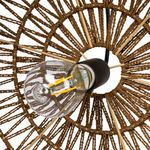 Close-up from below showing filaments inside clear bulb within woven paper rope frame