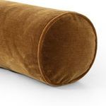 Close-up view of bolster pillow’s circular end showing velvet texture and piping