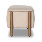 End view detailing rounded wooden legs and compact width of Emma Boucle trunk