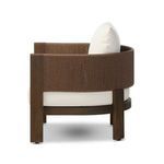 Side profile highlighting the rounded back of woven cording and plush seat cushion
