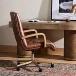 Close-up showing rich textured pattern of the cocoa leather upholstery.