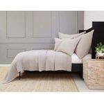Side view of Vancouver Coverlet showcasing drape and matching pillow shams against a gray paneled wall