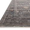 Lyra Ink rug angled shot highlighting soft texture, detailed floral design, and fringed edges