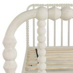 Curved top rail and spindle detail close-up on Jennifer Twin Bed’s headboard in antique white