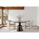 Two Elo Chairs flanking round dark wood table with white vase in sunlit corner room