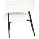 Side view highlighting Cassia chair’s open rounded backrest and tapered black metal legs
