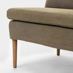 Close-up of side leg and upholstery with visible seam and fabric texture