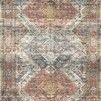 rectangular power-loomed rug with vintage-inspired geometric and floral patterns in apricot, mist blue, and muted earth tones