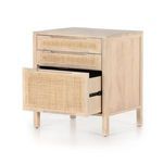 Front view showing detailed cane weave on all three drawer fronts