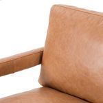 Partial view of mid backrest and armrest showing smooth leather finish and light sheen