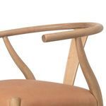 Close-up of curved ash wood armrest and backrest detail on Stowe Dining Chair