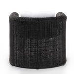 Back view highlighting tightly woven rounded wicker backrest and curved shape