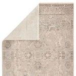 Rug corner folded back revealing lighter cream backing fabric and underside texture