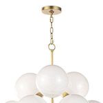 Close-up of top section of white swirl glass chandelier focusing on brass canopy and chain