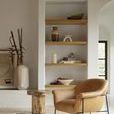 Contextual living space shot with chair angled beside wooden table and art piece