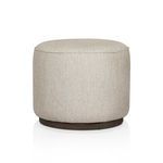 Rounded outdoor ottoman with light beige textured fabric and dark wooden base