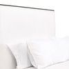 Upper torso view highlighting headboard with white pillows in front