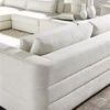 Close-up of sectional fabric texture and cushion stitching with vignette of decorative vases