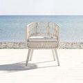 Dana Rope Dining Chair front view facing camera with ocean background and shadow on light wood deck